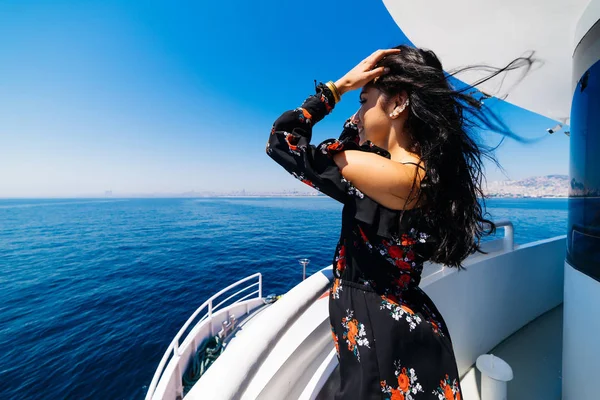 Freedom woman on yacht looking to the sea