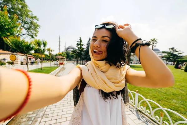 Uma garota engraçada mostra sua língua e faz selfie. Foto você mesmo — Fotografia de Stock