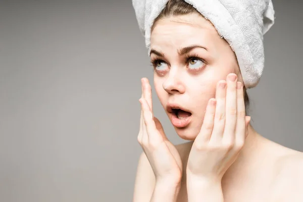 Девушка с полотенцем на голове заботится о своей коже. — стоковое фото