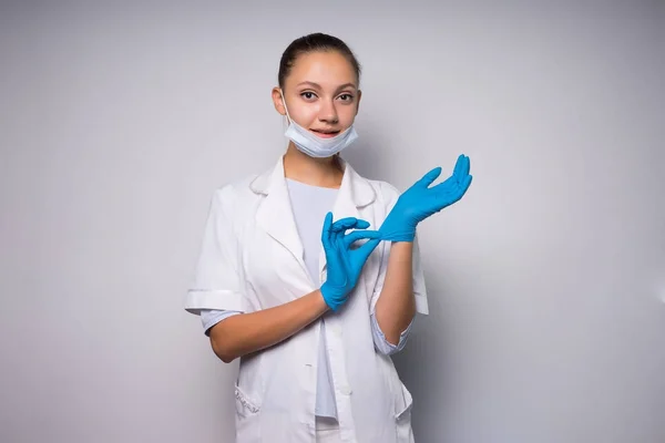 장갑에 흰색 보호 마스크 및 의료 드레싱 가운, 웃는 젊은 여자 의사 — 스톡 사진