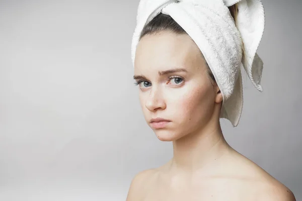 Beautiful woman with towel on the head looking to camera, smile — стоковое фото