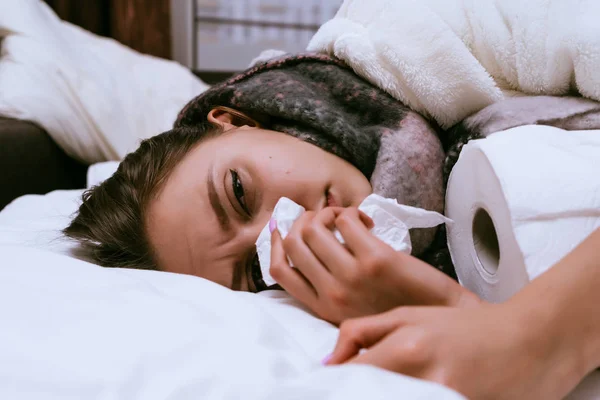 Sad young girl gets sick, sneezes, sore throat, neck warm scarf, feels bad — Stock Photo, Image