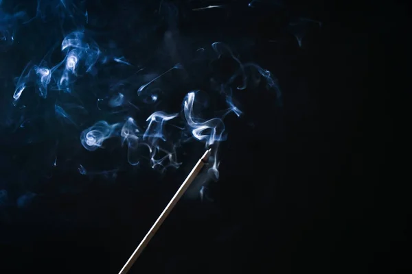 Sötét háttér előtt egy égő illatos-stick kék füst — Stock Fotó