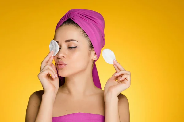 Αστείο κορίτσι που φροντίζει τον εαυτό της, καθαρίζει το δέρμα στο πρόσωπό της με τα μαξιλάρια βαμβακιού — Φωτογραφία Αρχείου