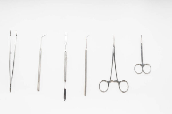 on the white surface are medical dental instruments