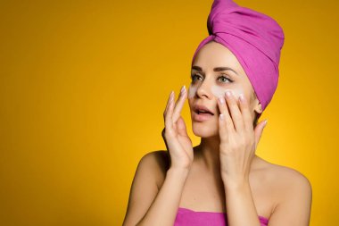 onun baş Tutkallar altında onun gözleri silikon yamalar üzerinde pembe bir havlu ile mutlu genç kız