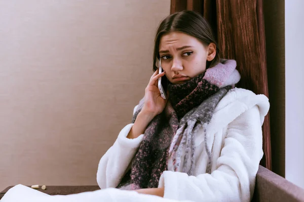 Sad young girl got sick with angina because of cold weather, talking on the phone — Stock Photo, Image