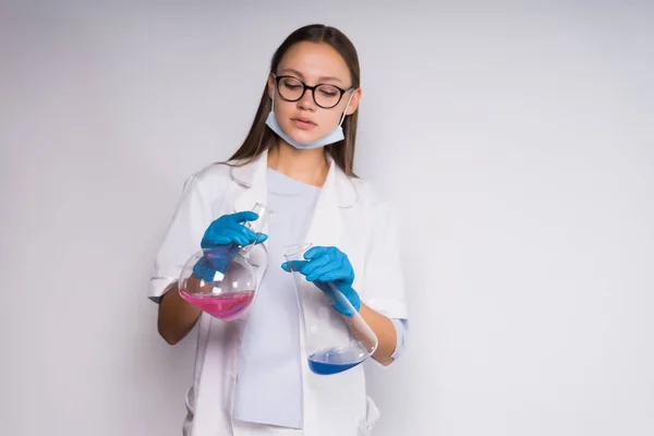 흰색 코트에 심각한 젊은 여자 화학자 화학 준비와 플라스 크를 보유 하 — 스톡 사진