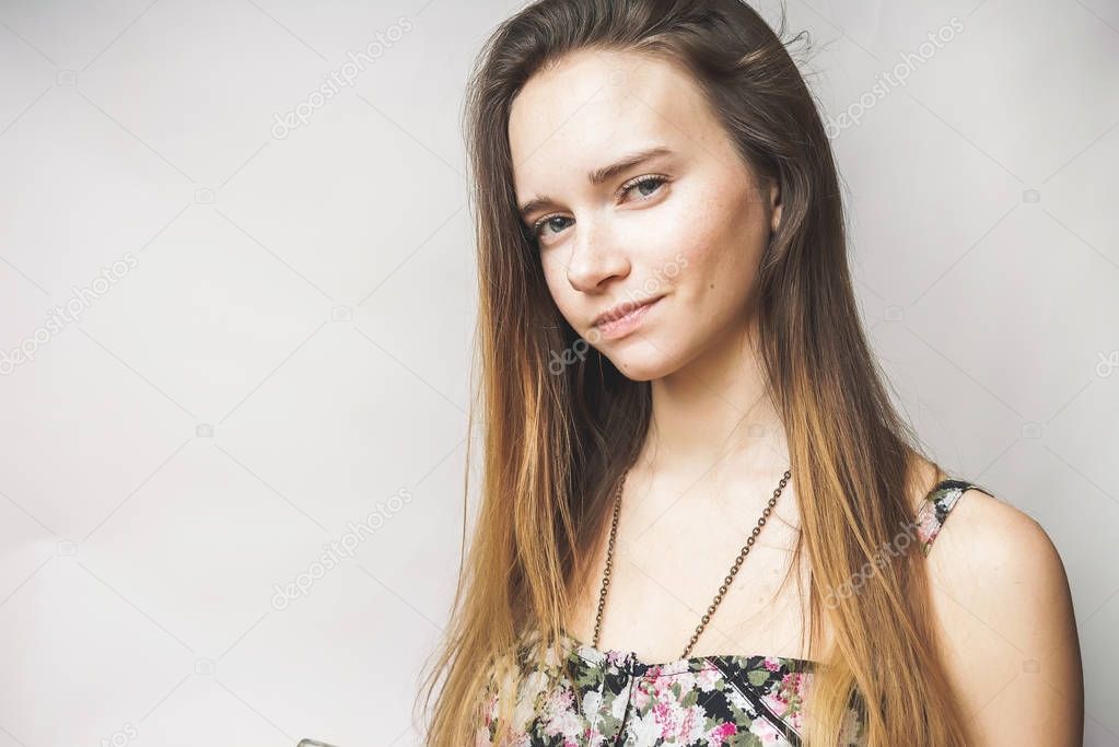 Skeptical smiling face girl on a white background