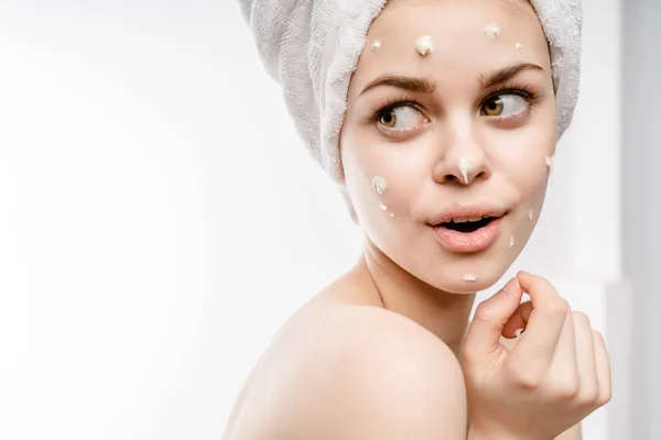 Young girl with a cunning expression on her face with a towel on her head — Stock Photo, Image