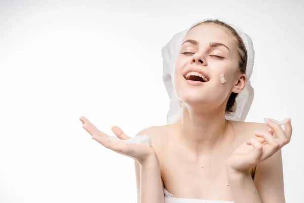 Girl in a towel and a shower cap smiling — Stock Photo, Image