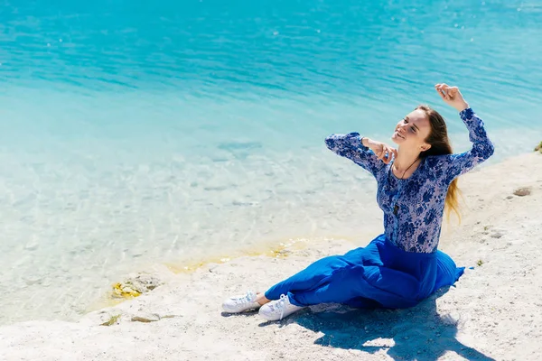 Freedom woman in free happiness bliss on beach. Smiling happy multicultural female model in blue summer dress enjoying serene ocean nature during travel holidays vacation outdoors