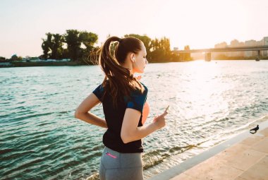 Sportif üniformalı genç kız bir akşam koşmak gerçekleştirir