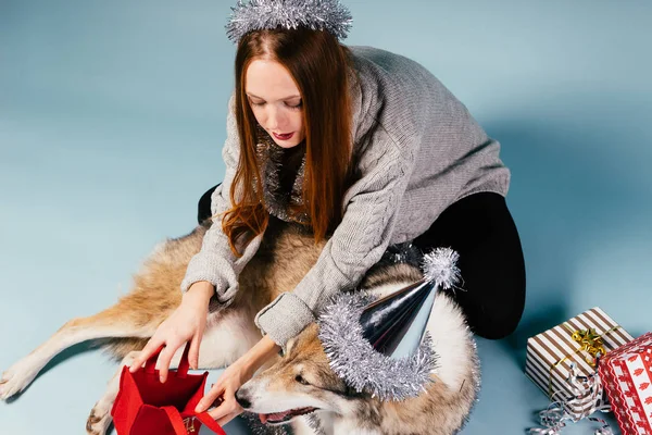 Fille avec un grand chien analyse cadeaux — Photo