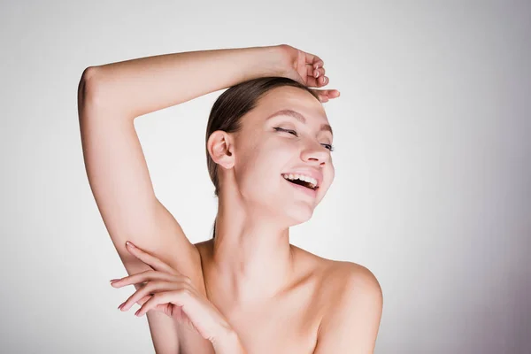 Happy young girl posing on gray background — Stock Photo, Image