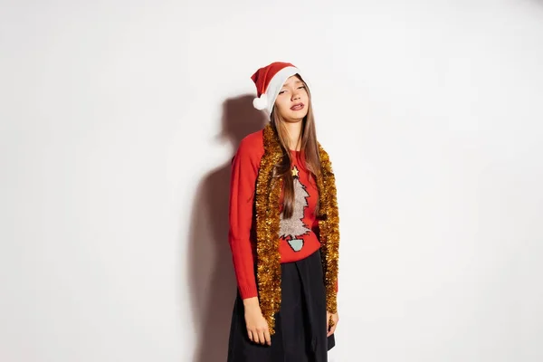 Lustiges junges Mädchen in roter Mütze und Pullover, müde vom Warten auf das neue Jahr 2018 — Stockfoto