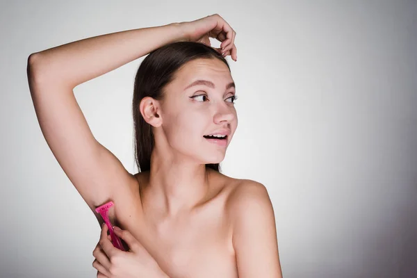 Sweet girl has put on her armpits aromatic deodorant — Stock Photo, Image
