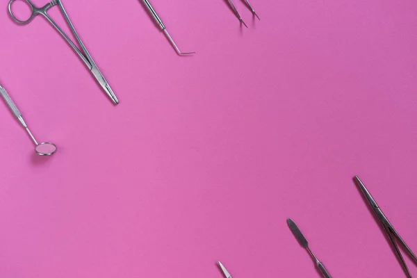 On the pink surface are dental medical instruments — Stock Photo, Image