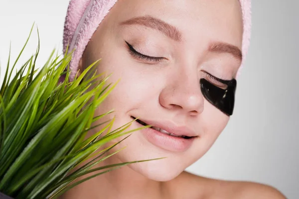 Young girl with black patches under the eyes on a white background — Stock Photo, Image