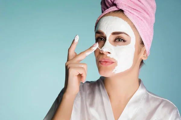 young girl removes the mask from the face