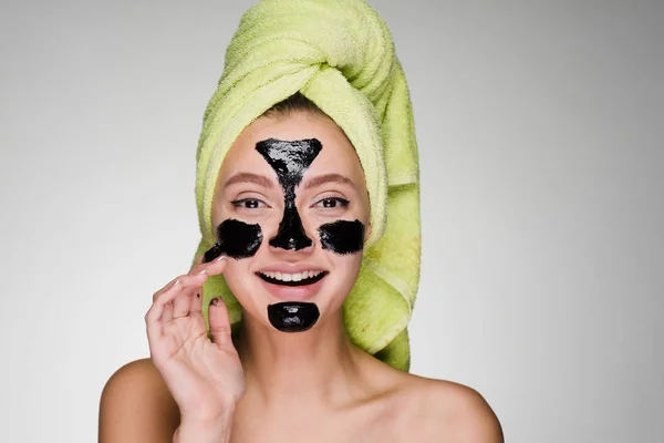 Young girl with black patches under the eyes on a white background — Stock Photo, Image