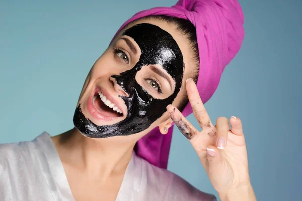 Young girl with black mask on her face smiling — Stock Photo, Image