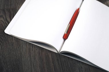 ahşap bir açık defter ve kalem geçerli