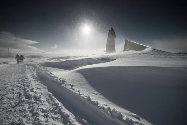 Mot bakgrund av ett snötäckt fält finns det två personer — Stockfoto