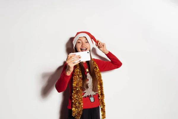 Happy girl in a New Year costume does selfie — Stock Photo, Image