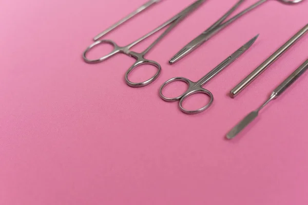 On a pink background is a dental instrument — Stock Photo, Image