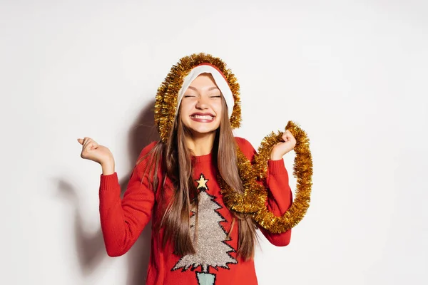 Menina feliz celebra o ano novo 2018, em sua cabeça um ouropel dourado, camisola de um Ano Novo vermelho — Fotografia de Stock