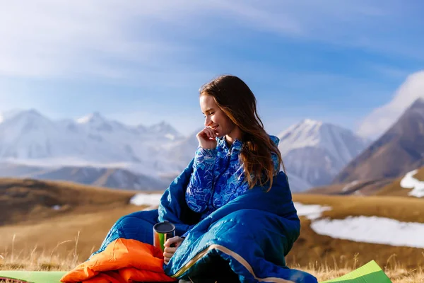 Sevimli genç kız Kafkas Dağları arka plan üzerinde oturur, derin derin düşünür, doğa ve güneş sahiptir — Stok fotoğraf