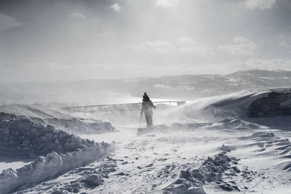 Kvinna i bakgrunden på ett snötäckt fält — Stockfoto
