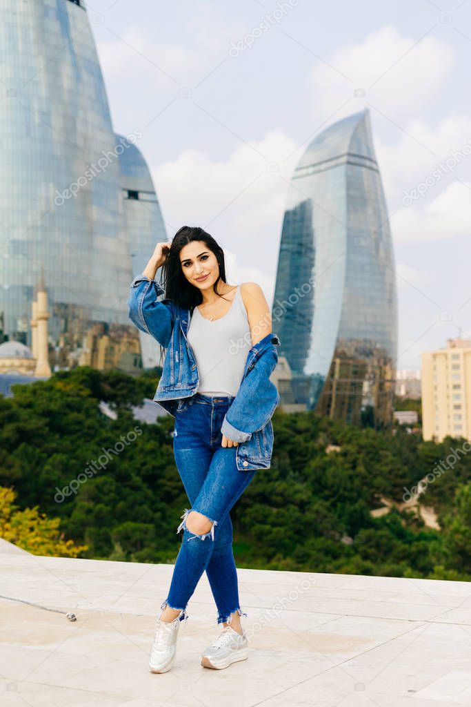beautiful stylish woman on the background of modern buildings