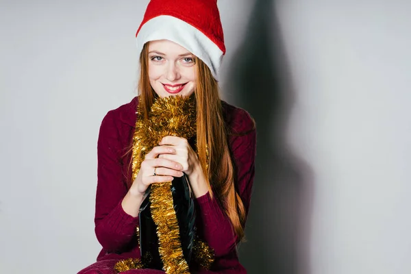 Glückliche Frau mit Neujahrsmütze und Flasche in der Hand — Stockfoto
