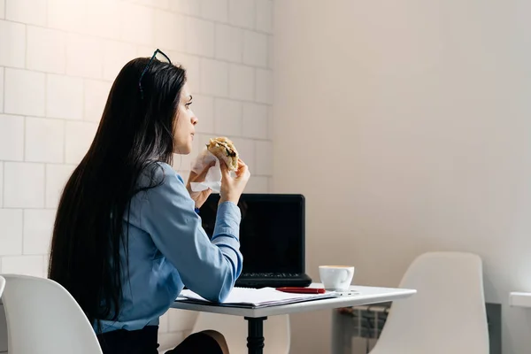 講演の前にカフェで朝食を持っている青いシャツを着て若い女子生徒 — ストック写真