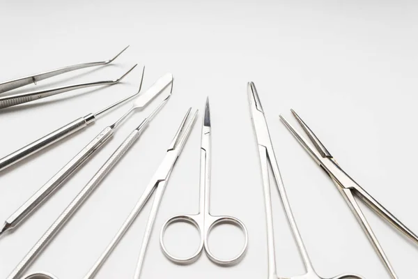 On a white table lie medical dental instruments — Stock Photo, Image