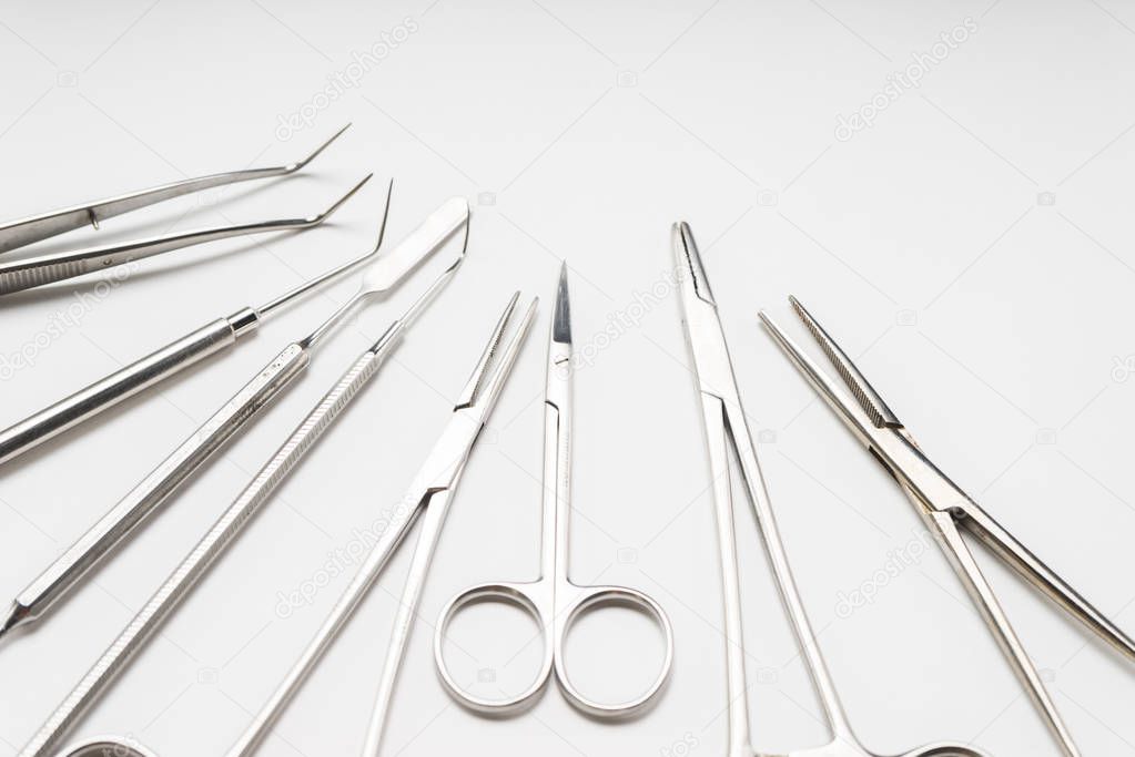 on a white table lie medical dental instruments