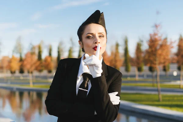 Letuška žena v uniformě na obloze na pozadí — Stock fotografie