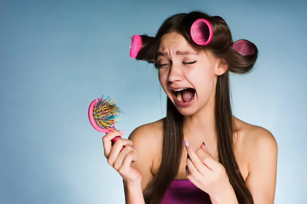 Frustrated with hair loss woman with hair curlers on her head — Stock Photo, Image
