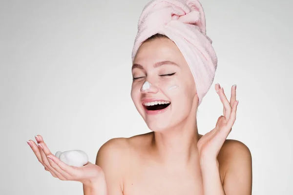 Happy woman with towel on her head after shower apply foam on face — Stock Photo, Image