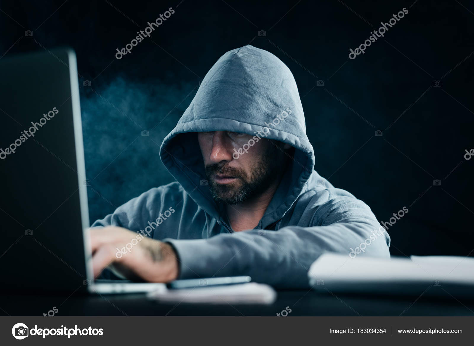 A Man Hacker Is Sitting In A Dark Room And What Is Typing In