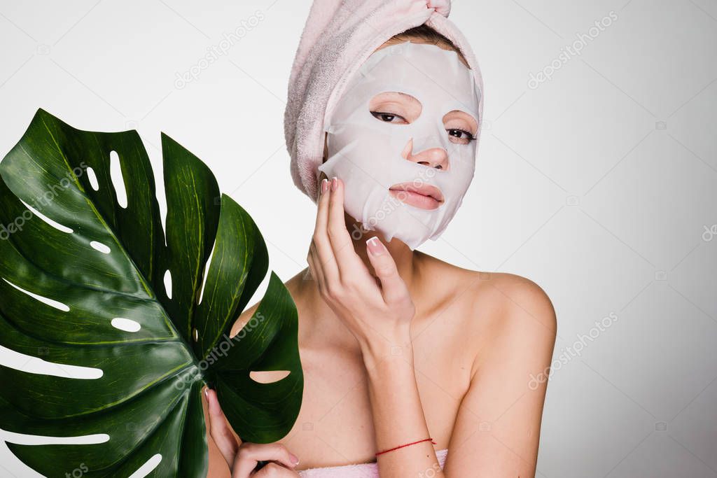 woman with a white mask on her face on a white background