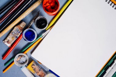 mavi bir arka plan üzerinde beyaz bir levha kağıt ve boya olduğunu