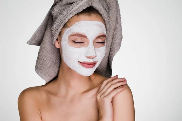 Seorang wanita bingung dengan handuk di kepalanya setelah mandi masker di wajahnya — Stok Foto