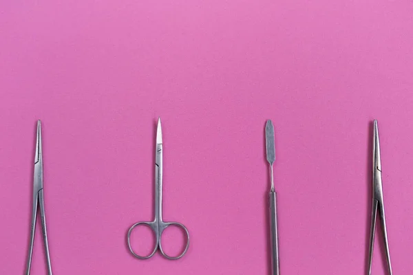 Sterile dental instruments lie on a pink background — Stock Photo, Image