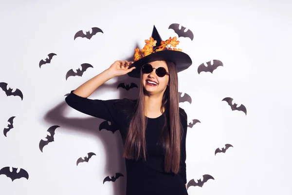 Šťastná žena v kostýmu čarodějnice na pozadí netopýrů — Stock fotografie