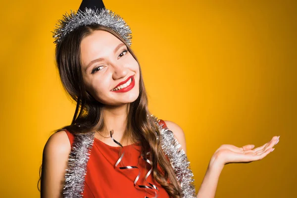 Happy young girl in red dress celebrates new year and christmas — Stock Photo, Image
