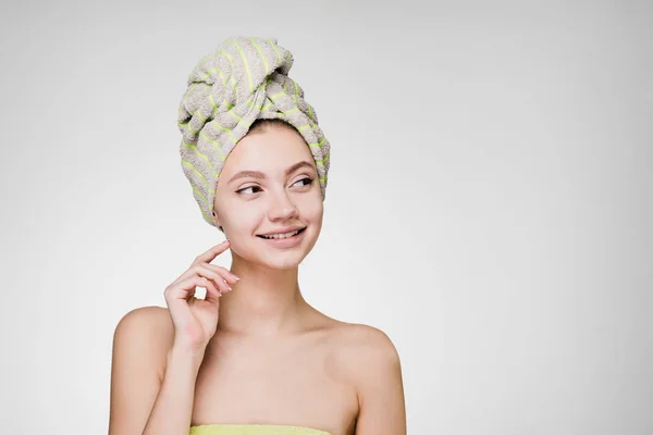 Happy woman with towel on her head after shower looks away — Stock Photo, Image