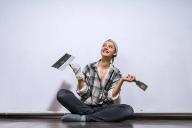 mutlu genç kız yerde, onarım yeni evinde kütük gibi duruyor